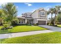 Charming two-story home boasting a lush lawn, colorful landscaping, and a spacious driveway, perfect for curb appeal at 5978 Anise Dr, Sarasota, FL 34238