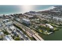 Panoramic aerial view of a beachfront community with condos, a marina and direct access to the ocean at 6415 Midnight Pass Rd # 204, Sarasota, FL 34242