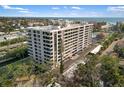 Exterior view of the building showing multiple units with balconies and lush landscaping at 6415 Midnight Pass Rd # 204, Sarasota, FL 34242