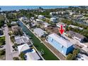 Aerial view of a modern blue two-story home located on a canal with boat dock at 654 Jungle Queen Way, Longboat Key, FL 34228