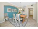 Charming dining room featuring a wooden table, neutral chairs, and colorful accent wall at 6914 Grand Estuary Trl # 101, Bradenton, FL 34212