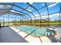 Screened-in pool overlooking the water, perfect for outdoor relaxation and entertaining at 7231 Brambury Ct, Sarasota, FL 34238