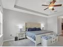 Serene main bedroom with tray ceilings, neutral colors, and stylish furnishings at 7418 61St E St, Palmetto, FL 34221
