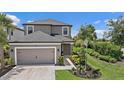 Charming two-story home featuring a two-car garage, manicured landscaping, and a welcoming front entrance at 7743 Nightfall Ter, Sarasota, FL 34241