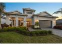 Well-maintained single-story home with landscaped yard and inviting covered porch at 8195 Redonda Loop, Lakewood Ranch, FL 34202