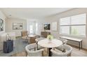 Bright and open living room with modern furnishings, neutral tones, and stylish decor at 10714 Hidden Banks Gln, Parrish, FL 34219