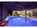 Beautiful covered outdoor pool area complete with outdoor kitchen, bar seating, and entertainment area at 10819 Wicker Park Pl, Palmetto, FL 34221