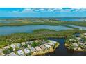 Stunning aerial view of waterfront property with lush landscaping, in a tranquil neighborhood at 11116 Sanctuary Dr, Bradenton, FL 34209
