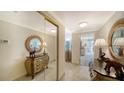 Inviting hallway with decorative mirrors and elegant furnishings leading to the living area at 1212 Benjamin Franklin Dr # 503, Sarasota, FL 34236