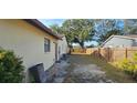 Backyard shows the exterior, including the wooden fence and some trees in the background at 1218 Carmella Ln, Sarasota, FL 34243