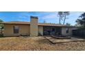 A backyard features a patio area, a chimney and green grass at 1218 Carmella Ln, Sarasota, FL 34243