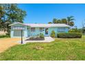 Inviting single-story home showcasing landscaping and a brick walkway at 1680 Lemon Bay Dr, Venice, FL 34293
