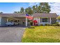 Charming villa with stone accents, carport, and beautifully manicured lawn at 2531 Riverbluff Pkwy # V181, Sarasota, FL 34231