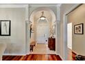 Bright foyer with beautiful wood floors, an arched doorway, and decorative architectural details at 3103 77Th E Dr, Sarasota, FL 34243