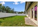 Large backyard featuring a well-maintained lawn, privacy fence, and access from the house at 3111 W Nassau St, Tampa, FL 33607