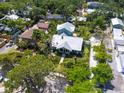 Aerial view of a home with a well-manicured lawn, lush landscaping, and a putting green at 324 Julia Pl, Sarasota, FL 34236