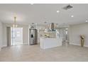 Open concept living room and kitchen area with modern appliances, tile flooring, and recessed lighting at 3370 Harbor Lake Dr, Largo, FL 33770
