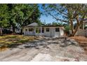Charming single-story home featuring a classic white facade and a spacious driveway at 4918 Lahaina Dr, Sarasota, FL 34232