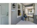 Inviting front porch with seating, a decorative lantern, and a view of the neighborhood at 5526 River Sound Ter, Bradenton, FL 34208