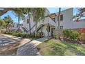 Exterior view of condo building with stairs, sidewalk and well-manicured landscaping at 564 Lakeside Dr # 564, Bradenton, FL 34210