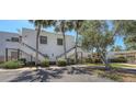 Exterior view of condo building with palm trees and well-manicured landscaping at 564 Lakeside Dr # 564, Bradenton, FL 34210