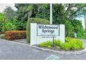 Welcoming sign for Wildewood Springs community at Oakview Drive surrounded by lush landscaping at 564 Lakeside Dr # 564, Bradenton, FL 34210