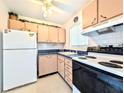 Kitchen featuring dated cabinetry, updated appliances, and a window for lots of light at 5951 Todd St # D37, Bradenton, FL 34207
