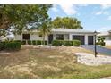 Well-maintained single-story home showcasing a manicured lawn and a convenient two-car garage at 624 Fort Duquesna Dr, Sun City Center, FL 33573