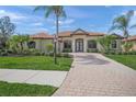 Charming single-story home boasting a brick-paved walkway and meticulous landscaping at 7659 Trillium Blvd, Sarasota, FL 34241