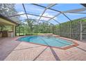 Refreshing screened-in pool and spa, complete with an outdoor grilling area at 7659 Trillium Blvd, Sarasota, FL 34241