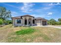 Single-story home featuring a landscaped front yard, arched entrance, and neutral color scheme at 8123 Wawana Rd, North Port, FL 34287