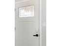 A modern white front door with decorative glass and a smart lock system at 8420 43Rd Avenue W Dr, Bradenton, FL 34209