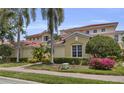 Beautiful two-story home featuring lush landscaping and a red tile roof at 927 River Basin Ct # 201C, Bradenton, FL 34212