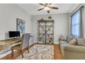 Well-lit home office with modern ceiling fan, wood floors, and comfortable seating at 927 River Basin Ct # 201C, Bradenton, FL 34212