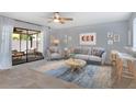 Bright living room with stylish furniture, ceiling fan, and sliding doors to outdoor space at 928 Sunridge Dr # F2, Sarasota, FL 34234