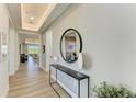 Bright entryway with decorative mirror and console table with views of the living room at 1007 Waterline Ct, Sarasota, FL 34240