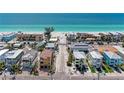 Beautiful aerial shot of homes leading to a white sand beach with crystal blue water at 101 25Th N St # 1, Bradenton Beach, FL 34217