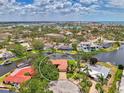 Scenic aerial view of waterfront property nestled amongst lush trees and a winding canal at 1038 Contento St, Sarasota, FL 34242
