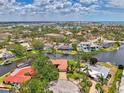 Scenic aerial view of waterfront property nestled amongst lush trees and a winding canal at 1038 Contento St, Sarasota, FL 34242