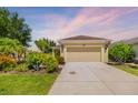 Lovely one-story home with a concrete driveway, and decorative front yard landscaping at 11634 Piedmont Park Xing, Bradenton, FL 34211