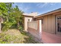 Cozy outdoor patio area featuring brick paving and a privacy wall at 1502 Water Oak S Way, Bradenton, FL 34209