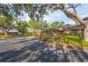 A neighborhood street view showcasing the architectural style of the homes at 1502 Water Oak S Way, Bradenton, FL 34209