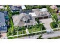 Expansive aerial view showcasing the property's layout, pool, and private backyard oasis surrounded by verdant landscaping at 1910 Datura St, Sarasota, FL 34239