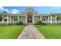 Stunning entrance with a decorative front door, well-manicured lawn, and inviting walkway showcasing the home's curb appeal at 1910 Datura St, Sarasota, FL 34239