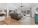 Spacious living room with hardwood floors, a ceiling fan, and sliding glass doors at 2049 E Leewynn Dr, Sarasota, FL 34240
