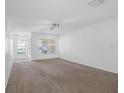 Bright and airy living room with carpet, large windows, and ample natural light at 220 Coquina Bay Dr, St Petersburg, FL 33705