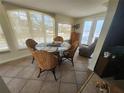 Well-lit dining area featuring a round glass table with seating for four and tile flooring at 300 N 22Nd St, Bradenton Beach, FL 34217