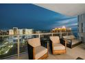 Relaxing balcony seating area with stunning city views and comfortable lounge furniture at 301 Quay Commons # 1709, Sarasota, FL 34236