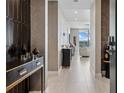 Elegant hallway with stylish console table, patterned wall decor, and tiled flooring at 301 Quay Commons # 1709, Sarasota, FL 34236
