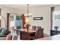 Cozy dining area featuring a modern chandelier and sliding door access to the outside at 309 Blue Point Dr, Ruskin, FL 33570